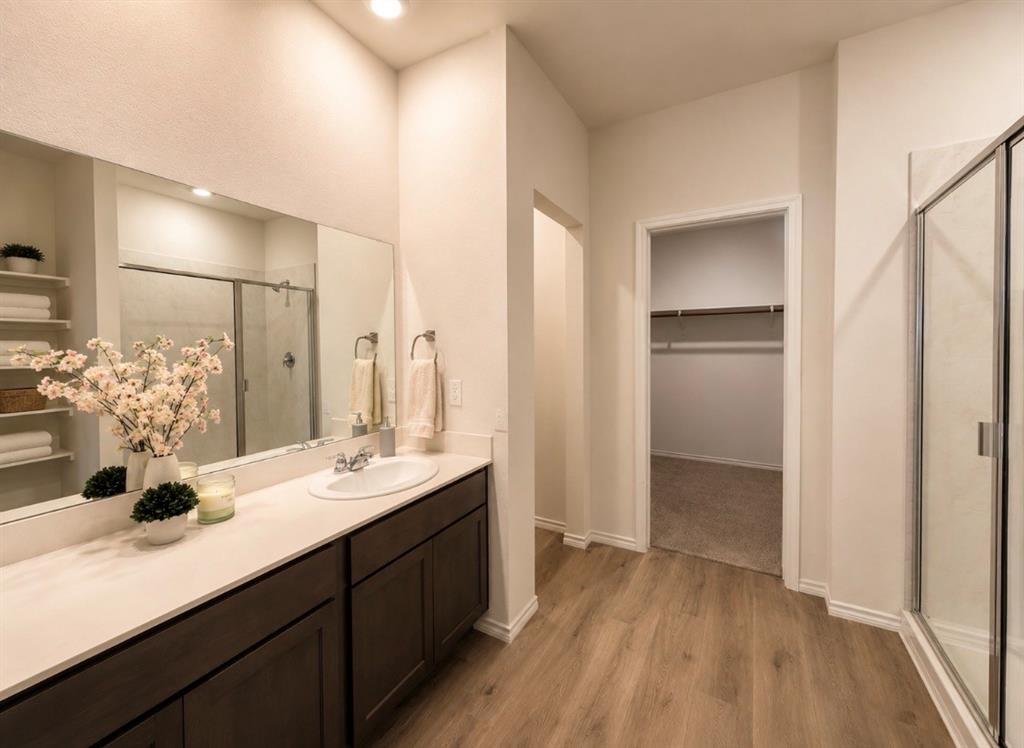 816 Country Road Royse City, TX 75189 - Photo 6 of 24 Bathroom featuring a dark wood-finish vanity with a single sink and white countertop, a frameless mirror, a glass-enclosed shower, wood-finish flooring, and recessed lighting