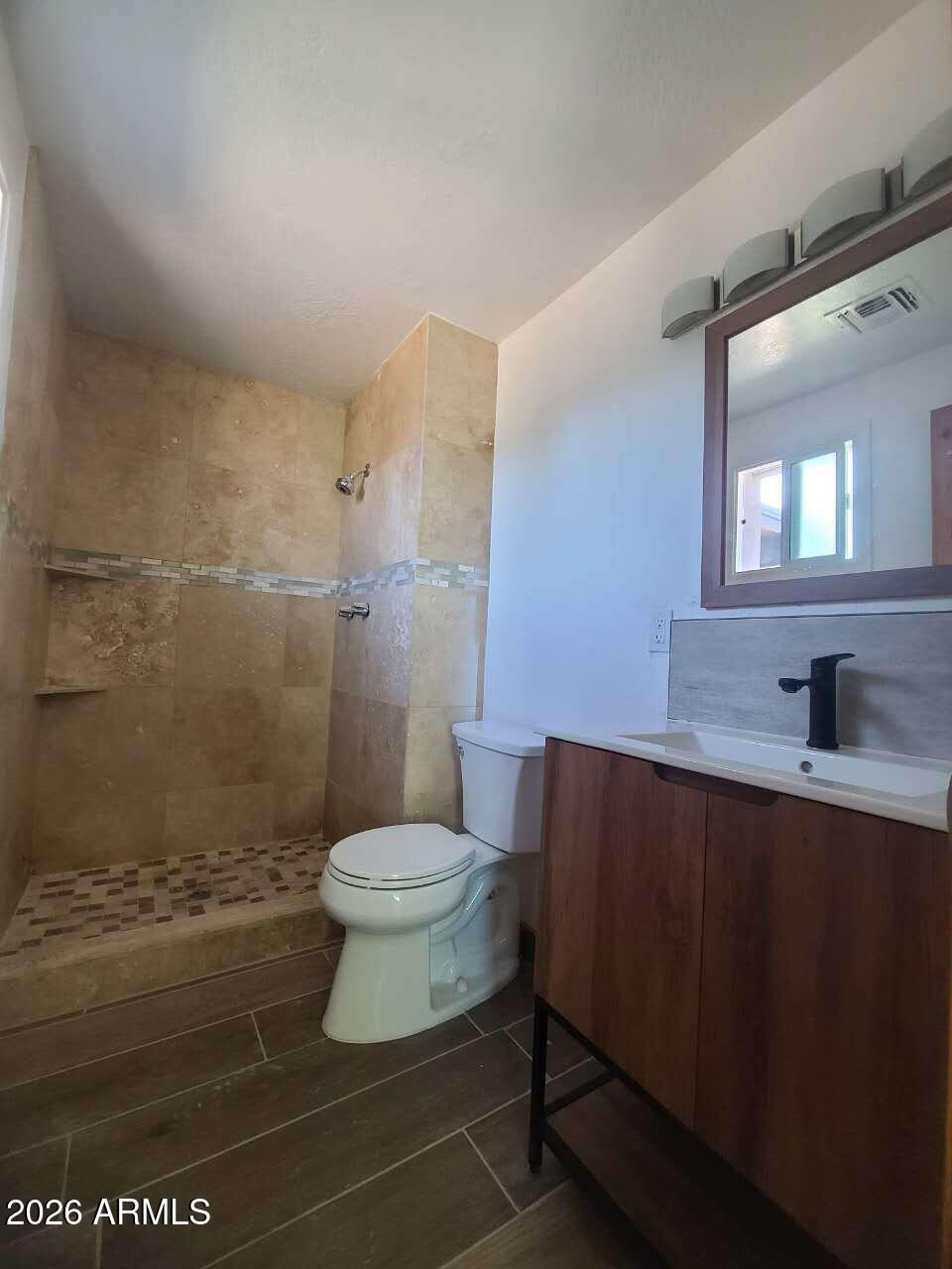 3702 East Thunderbird Road Phoenix, AZ 85032 - Photo 18 of 23 a bathroom with a sink a toilet and a mirror