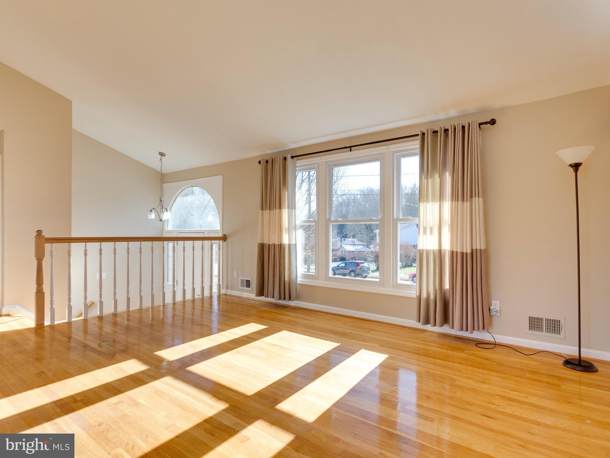 8702 Victoria Road Springfield, VA 22151 - Photo 2 of 27 a view of a big room with wooden floor and windows