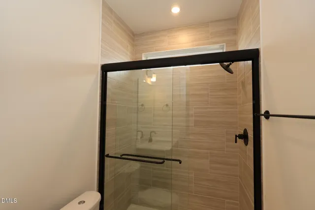 a bathroom with a shower and a toilet