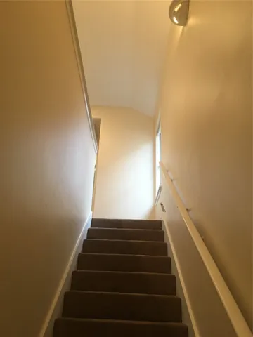 a view of a hallway with washer and dryer