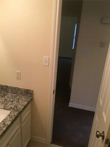 a bathroom with a granite countertop sink and vanity