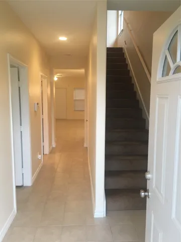 a view of a hallway with entryway and closet