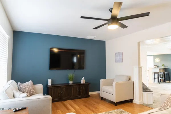 a living room with furniture and a flat screen tv