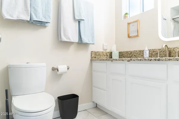 a white toilet sitting next to a bathroom sink
