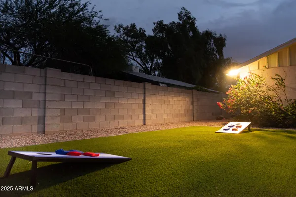 a backyard of a house with table and chairs