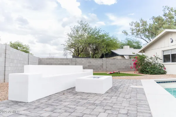 a view of white house with a swimming pool and a yard