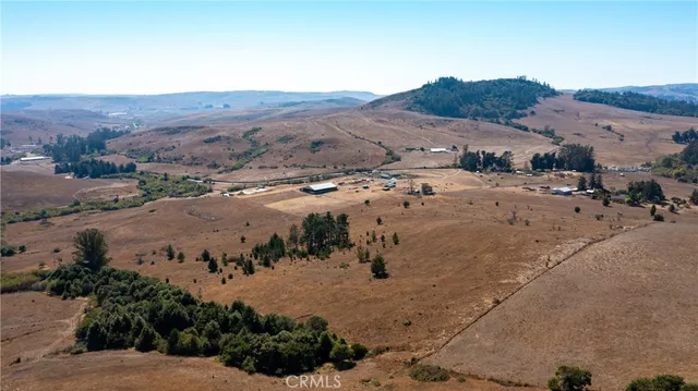 an aerial view of a house with a beach