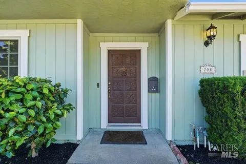 a front view of a house with a blue gate