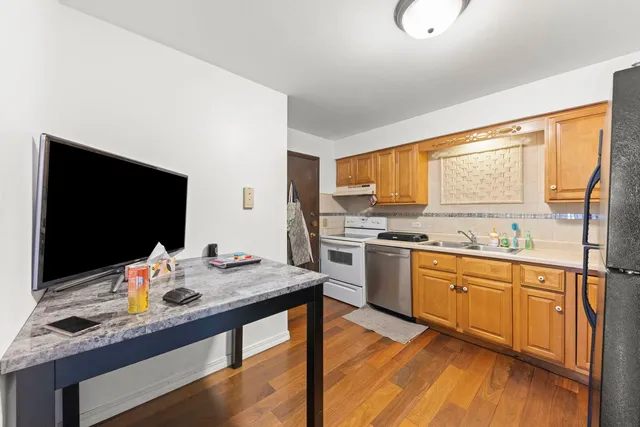 a kitchen with stainless steel appliances granite countertop a sink stove and cabinets