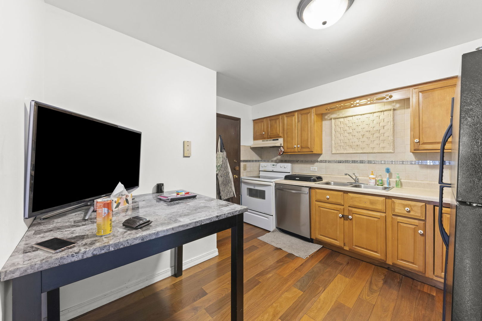 2343 Ogden Avenue, Unit 3 Downers Grove, IL 60515 - Photo 5 of 16 a kitchen with stainless steel appliances granite countertop a sink stove and cabinets