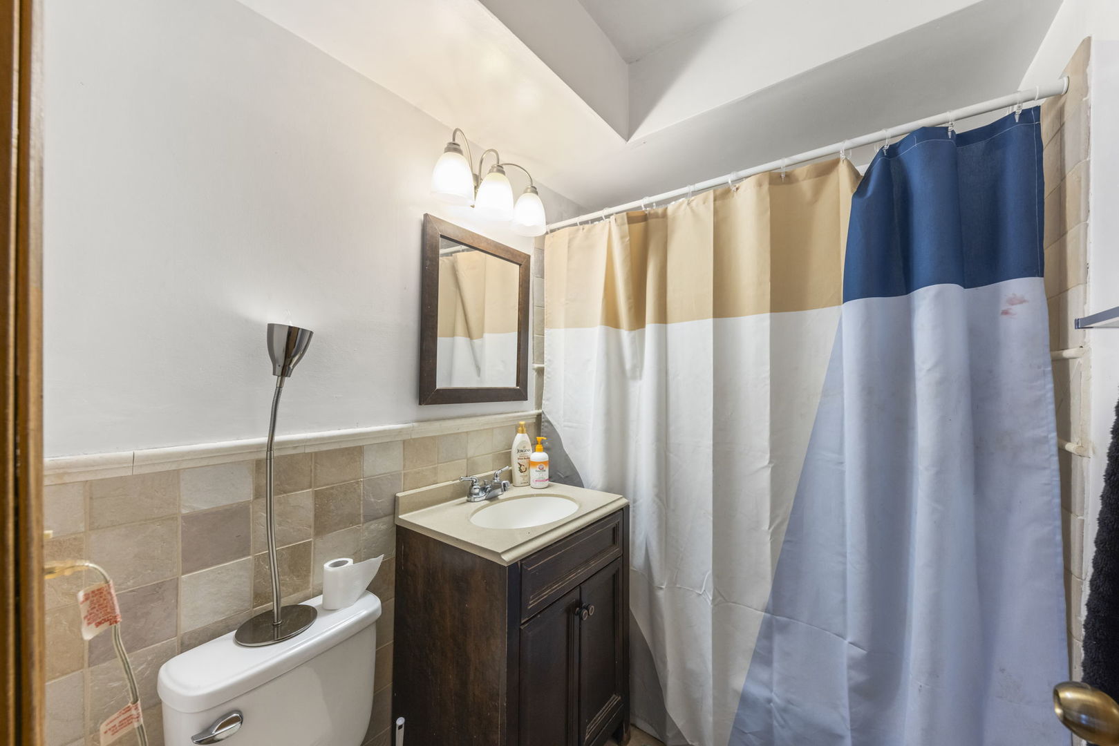 2343 Ogden Avenue, Unit 3 Downers Grove, IL 60515 - Photo 8 of 16 a bathroom with a sink a toilet and shower