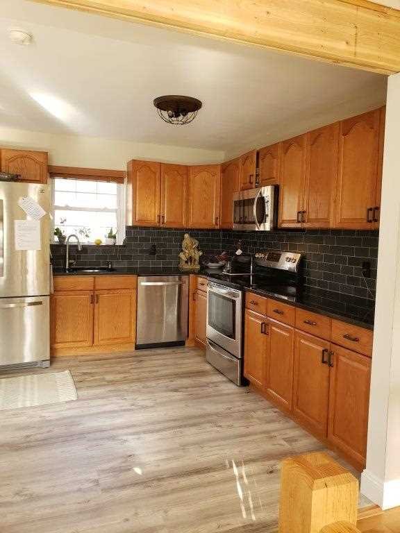 152 Belvedere Road Fishkill, NY 12508 - Photo 7 of 18 a kitchen with stainless steel appliances granite countertop a stove a sink and a microwave