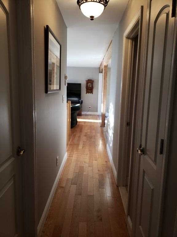 152 Belvedere Road Fishkill, NY 12508 - Photo 8 of 18 a view of a hallway with wooden floor and a bathroom