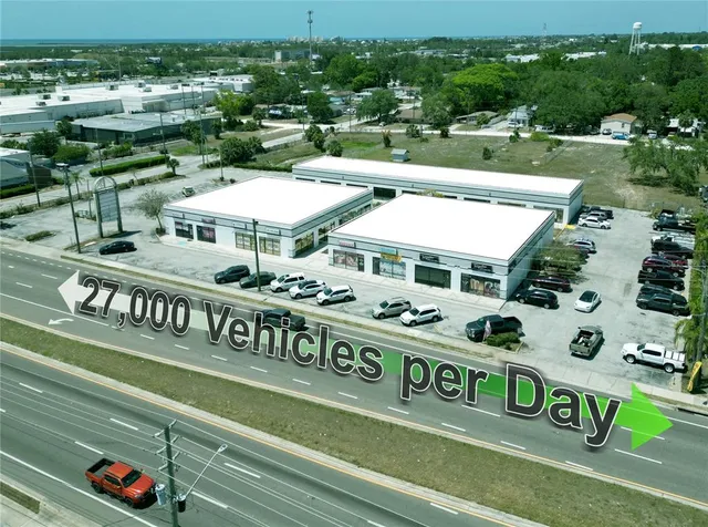 a view of a tennis ground with large trees