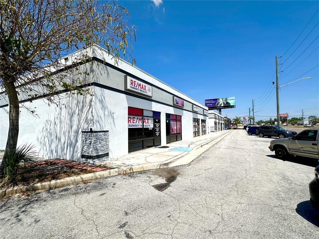 7135 State Road 52 Hudson, FL 34667 - Photo 12 of 14 a front view of a building with parking area