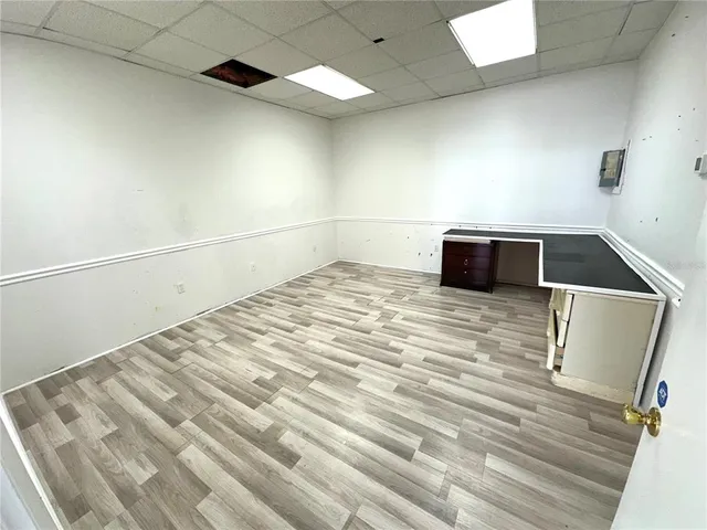 a view of a room with wooden floor