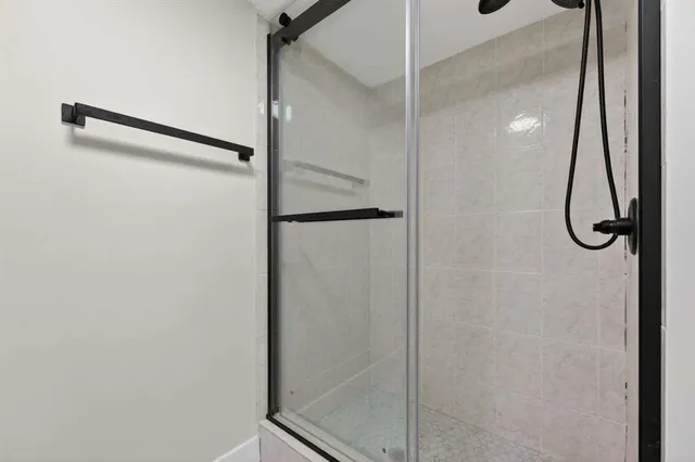 a bathroom with a glass shower door