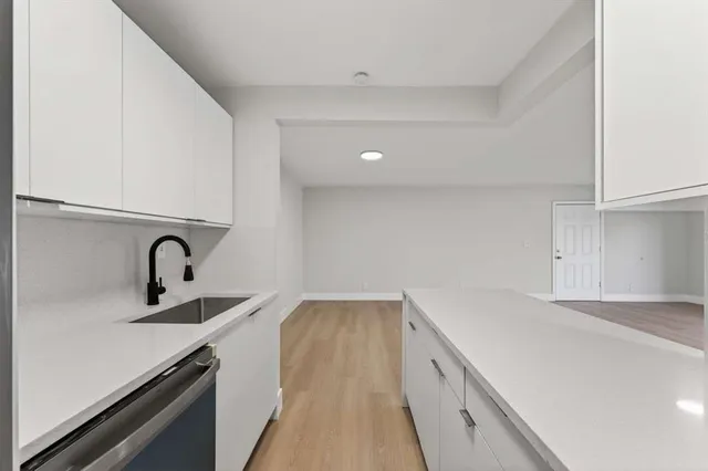 a view of a kitchen with sink and dishwasher