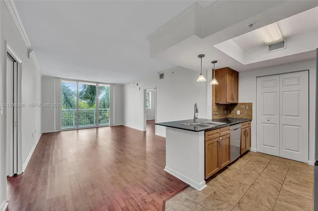 a kitchen with stainless steel appliances granite countertop a stove and a sink