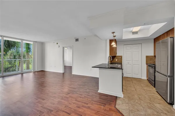 a kitchen with stainless steel appliances granite countertop a refrigerator and a stove top oven