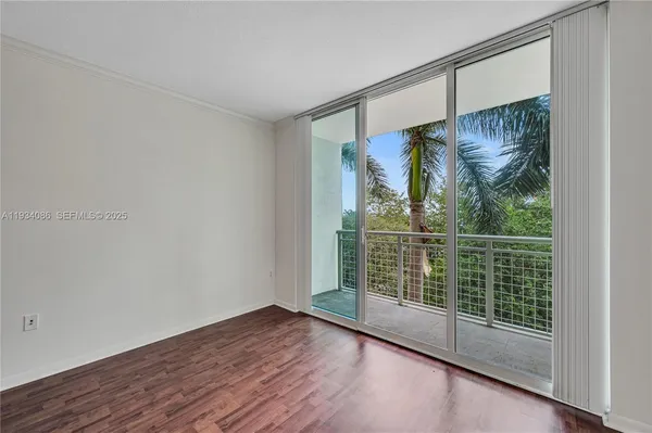 a view of a room with wooden floor and a window