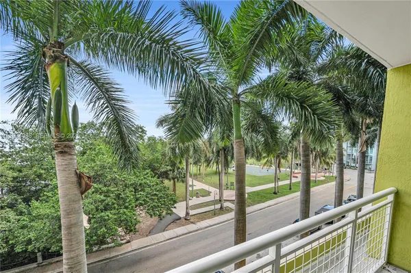 a view of a yard and palm trees