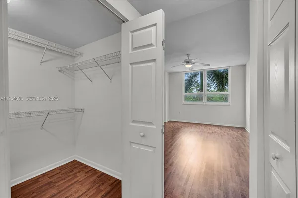 a view of room with hardwood floor and hallway
