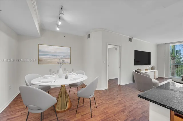 a view of a dining room with furniture and wooden floor