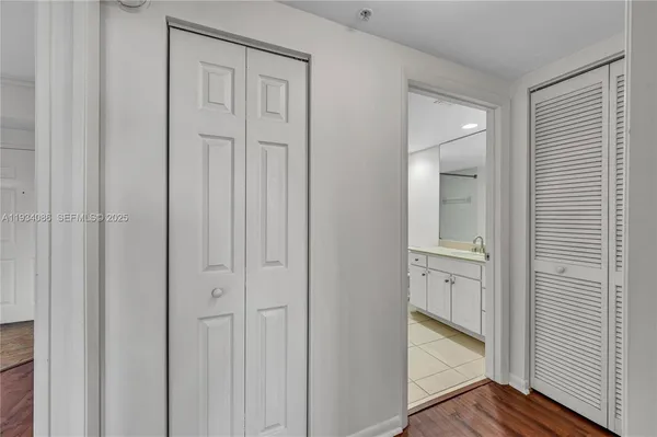a view of a hallway with wooden floor