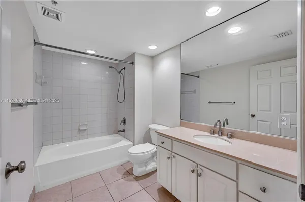 a bathroom with a double vanity sink toilet mirror and bathtub
