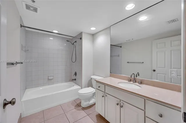 a bathroom with a double vanity sink toilet mirror and bathtub