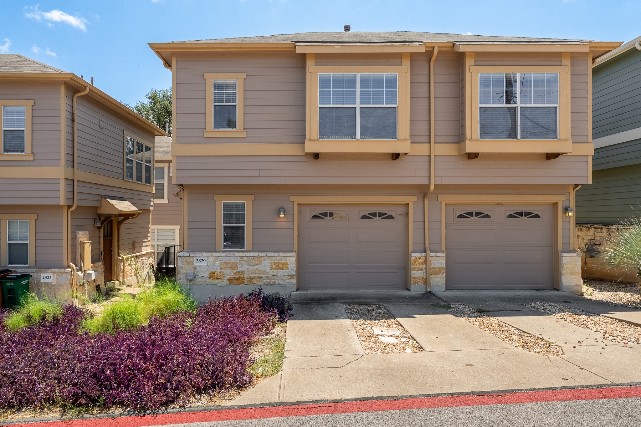 2829 Saville Loop, Unit 17C Austin, TX 78741 - Photo 1 of 28 A well-maintained two-story residence presents a neutral color palette with charming stone accents and individual garage access.