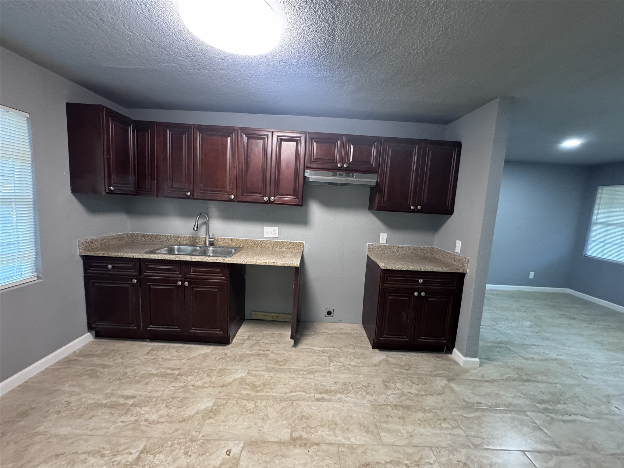 4933 Alvin Street Houston, TX 77033 - Photo 2 of 9 a kitchen with granite countertop a refrigerator and a sink
