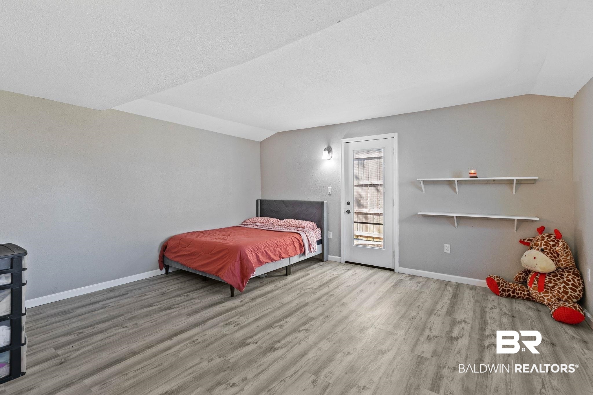 16796 Thompson Road Loxley, AL 36551 - Photo 34 of 93 Bedroom featuring light wood-style flooring and vaulted ceiling