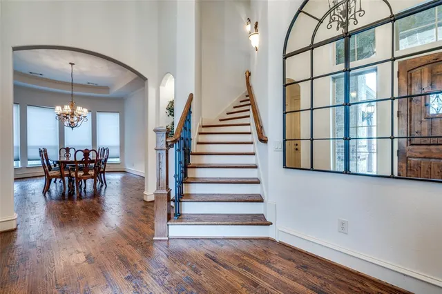 a view of entryway and dining room with wooden floor