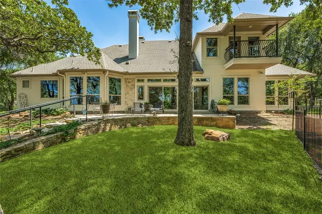 a front view of a house with a yard table and chairs