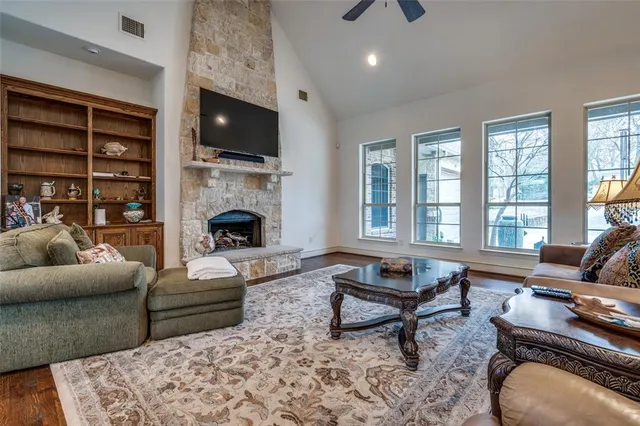 a living room with furniture fireplace and rug