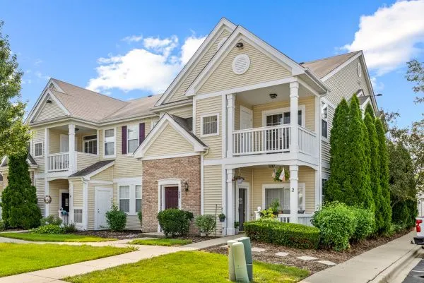 a front view of a house with swimming pool and glass windows