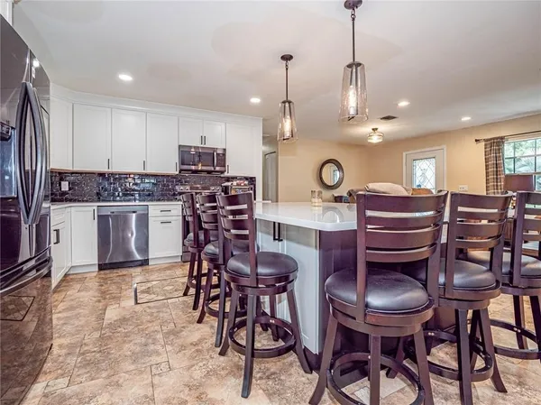 a kitchen with a dining table and chairs