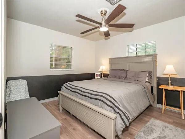 a bedroom with a bed and a chandelier