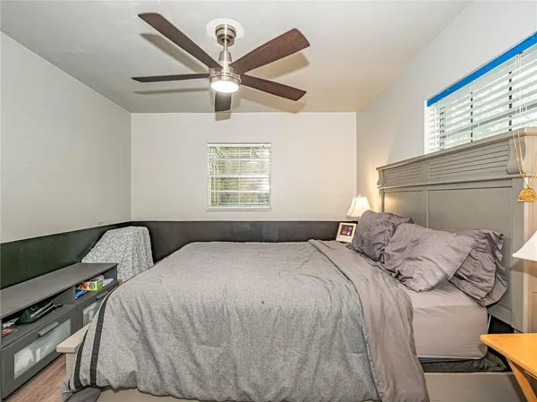 a bedroom with a bed and a window