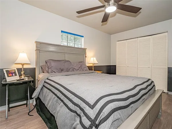 a bedroom with a bed and a chandelier