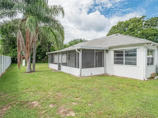 a view of a house with a yard and tree s