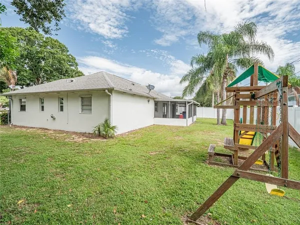 a view of a house with a backyard
