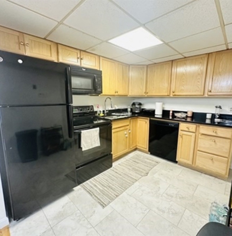 a kitchen with stainless steel appliances granite countertop a sink counter space cabinets and a large window