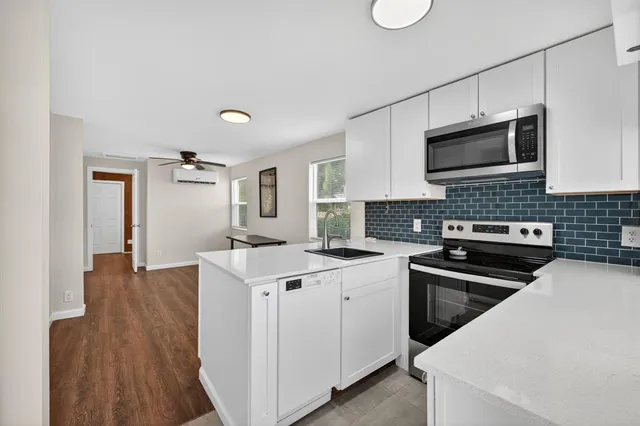 a kitchen that has a sink and a stove in it