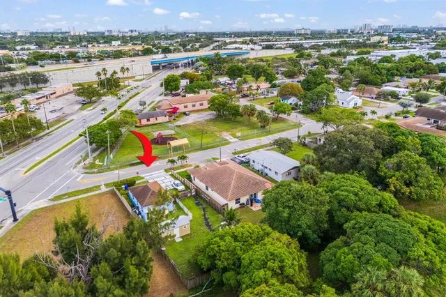 an aerial view of residential houses with outdoor space and river