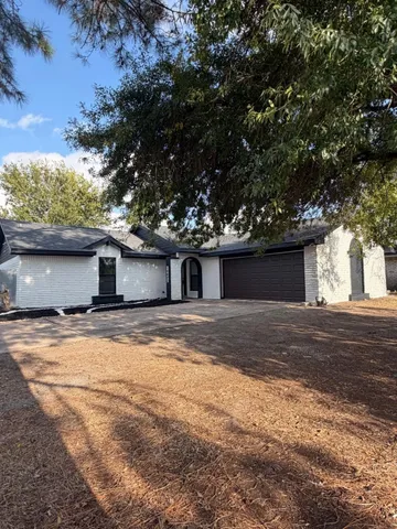 a view of a house with a yard and garage