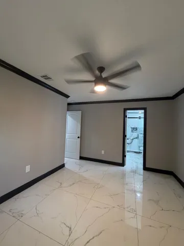 a bathroom with a granite countertop sink mirror vanity and toilet